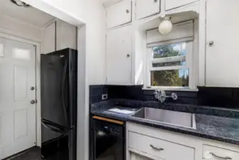Kitchen features matching appliances and window above the sink.