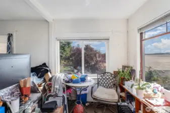 Upstairs bedroom features a cozy nook, great for reading and enjoying this calming view.