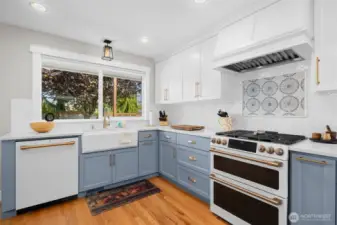 Stunning chef’s kitchen with farmhouse sink, gas range, and designer finishes