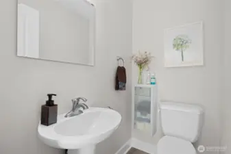 Crisp half bath with pedestal sink and modern finishes