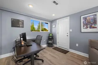 Bright bonus room with attached garage entry and large window views
