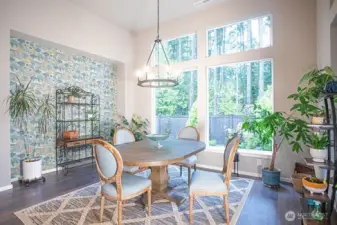 Dining area with a view of the backyard and the greenbelt beyond