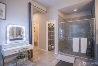 Primary bath with oversized shower and linen closet beyond