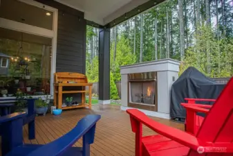 private deck with outdoor fireplace