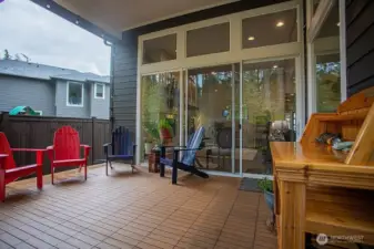 Spacious deck looking back into living room with large sliding glass door.