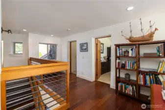 Open hallway with office first door and flex room (w/closet) second door..