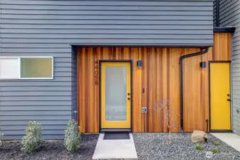 Vertical cedar siding defines the exterior with warmth and texture, setting the architectural tone.