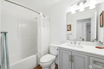 Fresh, functional, and roomy, twith clean finishes- the full bath off the hall is designed for ease of use and access.