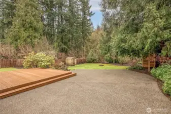 Open grassy yard surrounded by trees for added privacy.