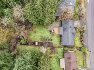 Aerial view of the home nestled among trees on a spacious lot.