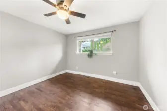 Bedroom 1: Ceiling fan, window, wood blinds, and large closet with built in shelving (not pictured).