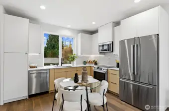 The kitchen features Abodian cabinets, quartz counters, under-cabinet lighting, & SS appliances.