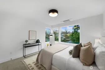 The spacious primary suite has large corner windows.