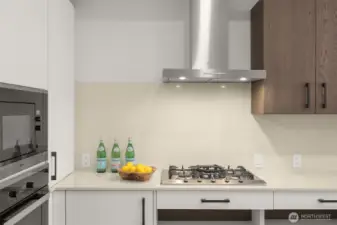 Miele appliances, quartz countertops, gas range and ADA Custom Cabinetry