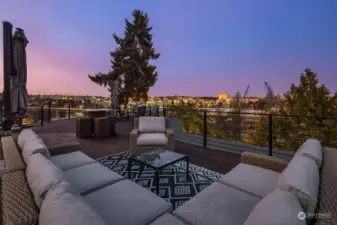 Spacious rooftop deck with variety of seating areas, all with stunning views.