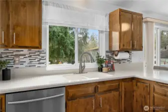 Kitchen window overlooks upper deck and backyard