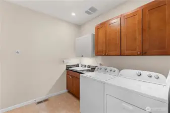 The washer and dryer are included in the sale.  And look! There's a laundry sink.