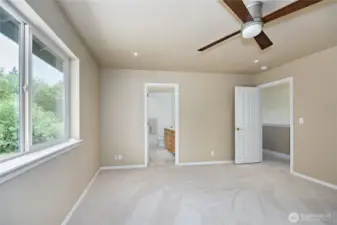 Nice sized primary bedroom with 5 piece bath beyond.