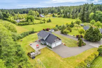 Aerial shot of the home on a shy acre surrounded by farmlands.