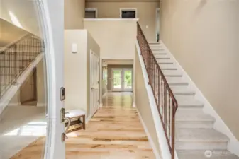 An entry that impresses with its sanded/re-stained wood floors and iron stair railing.