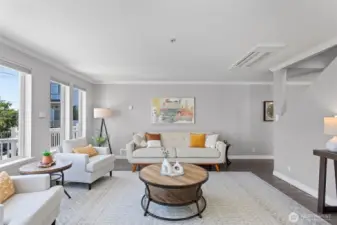 The living room is spacious and separated from the dining and eating areas.