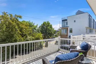 One of two decks. This one out front off the living room, separated from the street by the driveway and large hedge.