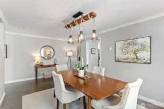 The entertainment sized dining room features a 3-light linear chandelier and has easy access to the kitchen.