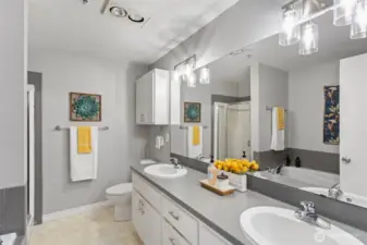 Primary ensuite full bathroom with stand alone shower and double vanity.