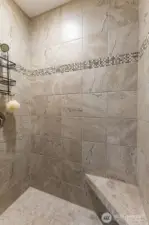 Private shower area with bench.
