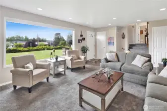This shot highlights the staircase leading up to the upstairs bedrooms and bathrooms, while the door on the right provides access to the basement.