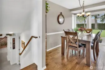 The dining area sits just off the kitchen, with the entrance to the basement conveniently located to the left.