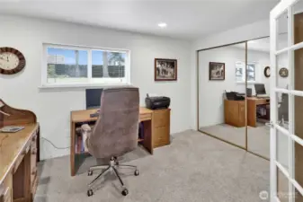 The fourth bedroom or office is conveniently located off the basement rec room, offering flexibility for work, guests, or hobbies.