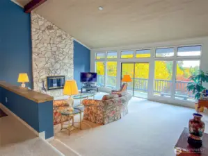 Huge living room with stone fireplace and vaulted ceilings