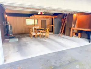 Large 2 car garage with storage areas and locking room.