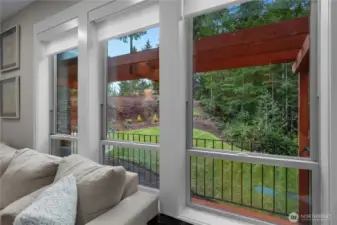 Open windows looking to the lawn and covered deck.