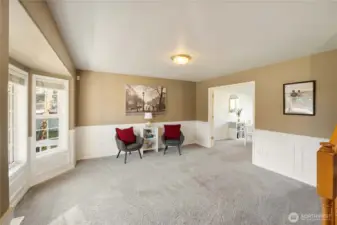 Spacious living room leads through French doors into formal dining