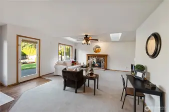 Large great room adjacent to kitchen with eating area. Cozy gas fireplace and access to fully fenced backyard