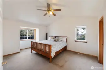 Spacious primary suite with attached 5 piece bath and walk in closet