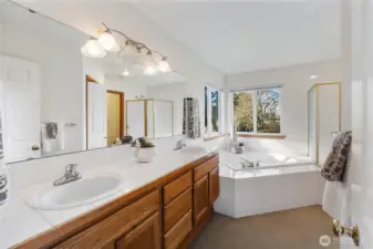 Primary bath features dual vanity, soaking tub and separate show