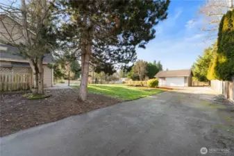 Side gate leads to additional parking area into backyard