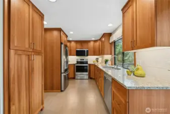 Updated kitchen featuring rich wood cabinetry and granite countertops.