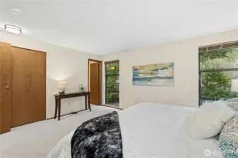 Large windows bring natural light into the primary suite.