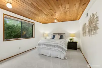 Lower level bedroom providing privacy for guests or multi-generational living.