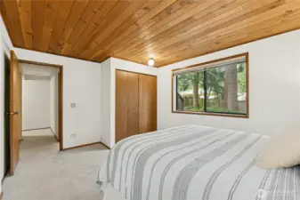 Lower level bedroom providing privacy for guests or multi-generational living.