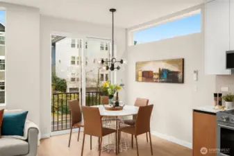 An inviting open-concept main floor features soaring ceilings and expansive windows that flood the space with natural light