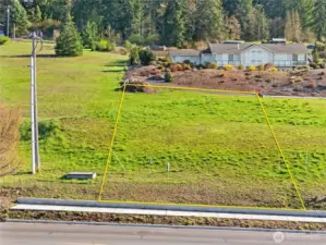 South-facing view from Miller Rd.  Boundary lines are approximate, the East boundary line runs from the top left corner marker to marker by the power pole.  All corners are marked.