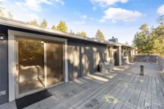 Main floor balcony with sliding glass doors from living room and primary bedroom