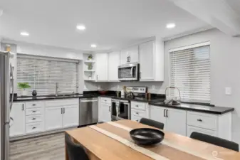 Updated kitchen with new appliances and black granite countertops