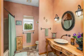 Full bathroom off of the guest suite with a linen closet.