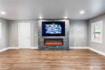 Electric fireplace in living space and the tv conveys. Note the security system display.